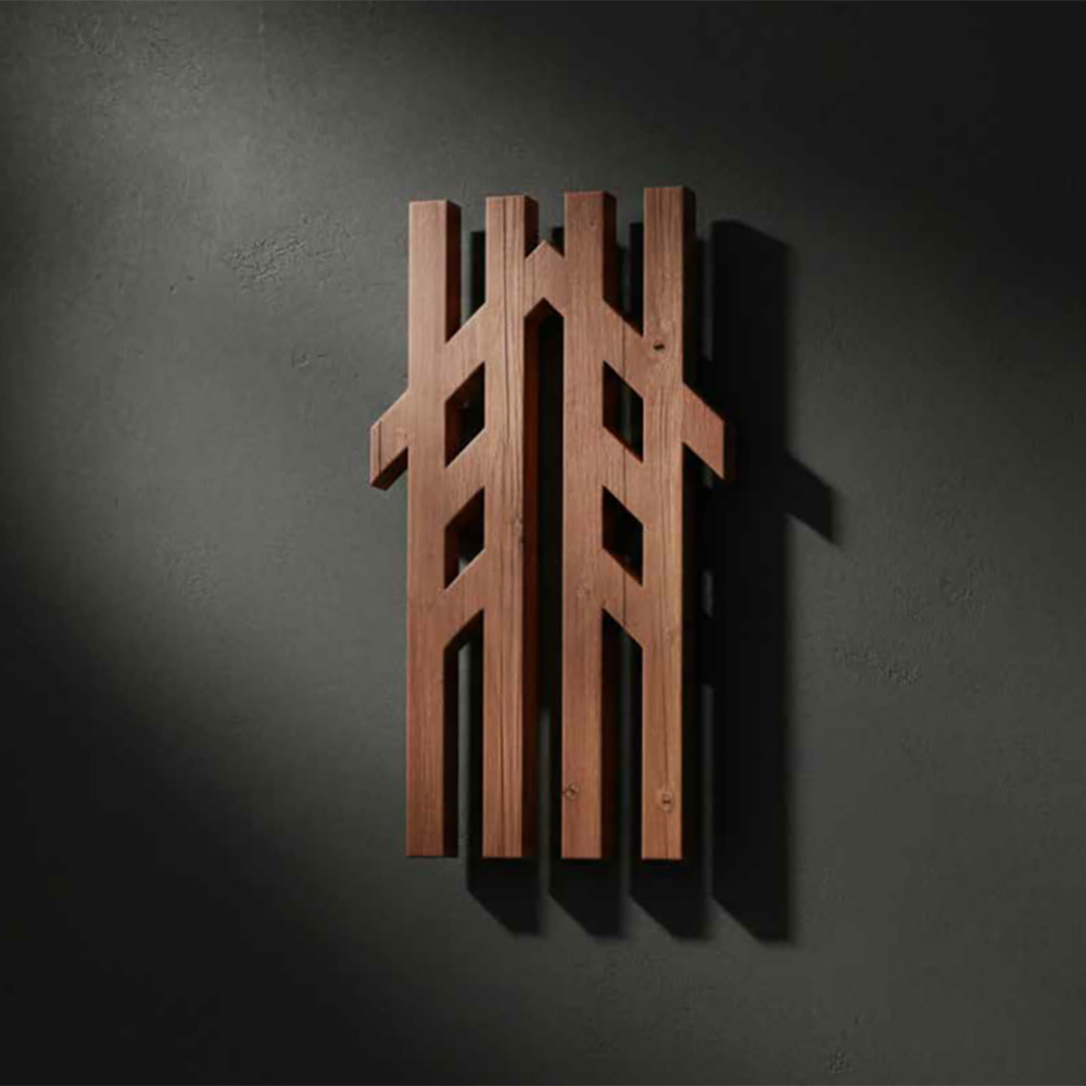 Wooden carving of the Te Manawataki o Te Papa logo.