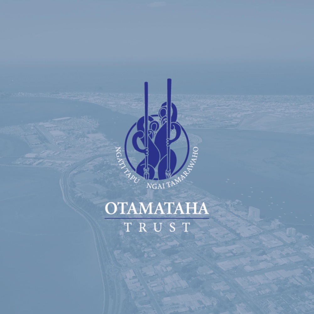 Otamataha Trust logo over an aerial view of Tauranga.